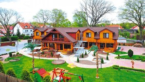 A large wooden house with multiple rooms and a covered porch. - Comfortable Holiday Home Close to the Beach (Ustronie Morskie)