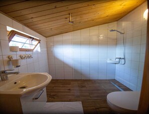 A bathroom with a wooden ceiling, a sink, a toilet, and a shower. - Bungalow in Miedzyzdroje Near Baltic Beach (Międzyzdroje)