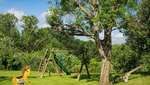 A playground with a swing set and a seesaw. - Apartment in Montaione With Fireplace (Montaione)