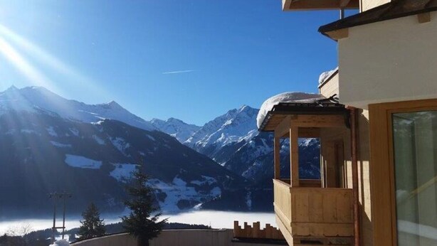 A wooden chalet with a view of snow-covered mountains and a clear sky. - Kitzbuhel Alpine Lodge With Private Infrared Sauna (Mittersill)
