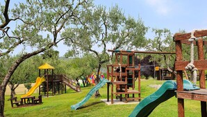 A playground with slides and climbing structures. - Apartments Poiano in Garda (Garda)
