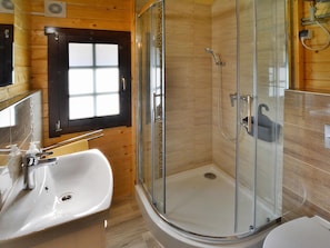 A modern bathroom with a glass-enclosed shower, a white sink, and a small window. - Holiday Homes With Terraces, Close to the Beach (Ustronie Morskie)