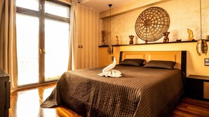 A hotel room with a large bed, a ceiling fan, a large window with curtains, and a decorative wall piece. - Holiday Home Near Baltic Sea & Swinoujscie (Swinoujscie)