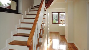 A wooden staircase with white walls and a wooden floor. - Holiday Home Near Baltic Sea Beach (Międzyzdroje)
