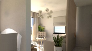 Ein modernes Wohnzimmer mit einer Couch, einem Sessel, einer Topfpflanze und einem Fernseher.