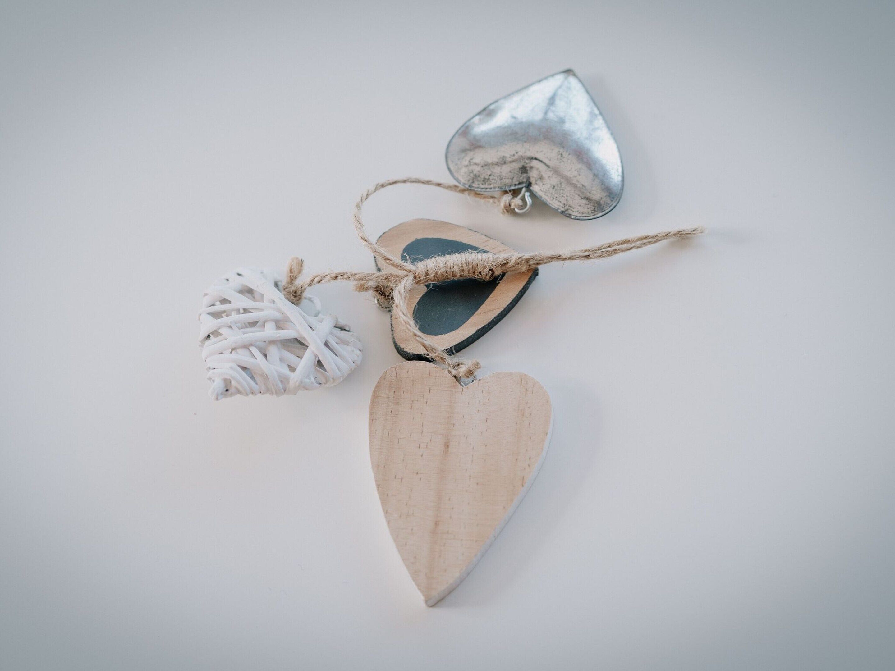 Three wooden heart-shaped ornaments tied with a string.