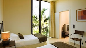 A hotel room with two beds, a lamp, a chair, and a television in the corner. - Holiday Home, Maspalomas (San Bartolomé de Tirajana)