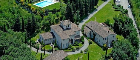 A large estate with multiple buildings, a swimming pool, and a well-maintained garden.