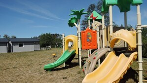 A playground with slides and climbing structures. - Dziwnowek Holiday House Near Beach (Kamien Pomorski)