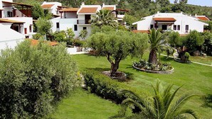 A residential area with white buildings, red-tiled roofs, and lush greenery. - Gerakini Holiday Home With a Balcony (Polygyros)