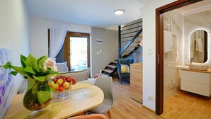 A modern living room with a dining area, a staircase, and a bathroom. - Holiday Home in Mielenko Near Seaside Beach (Mielno)
