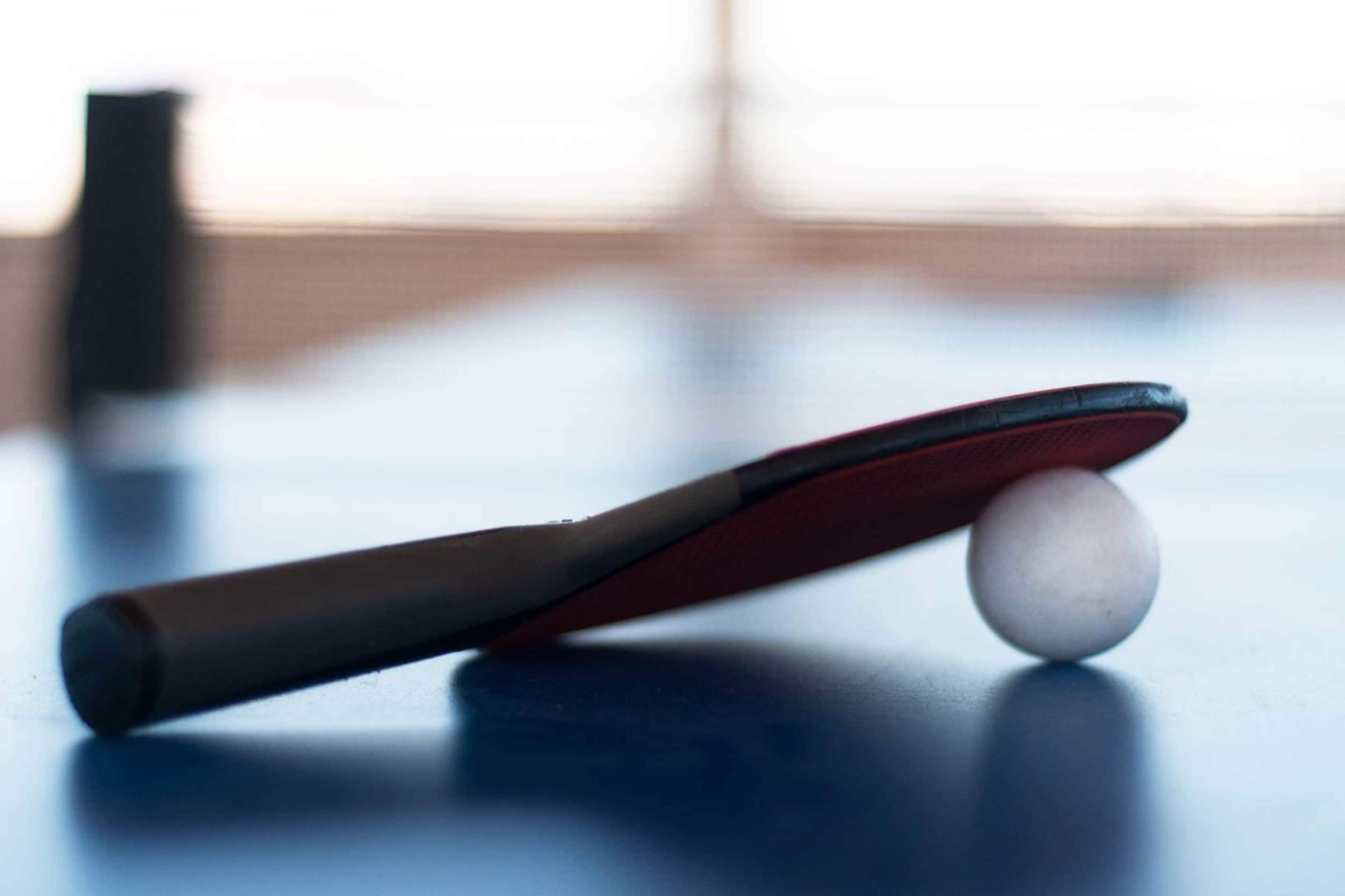 A billiards cue with a white cue ball on a table.