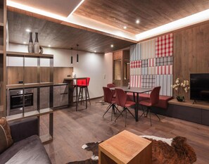 Relax in this stylish space with a kitchen, dining area, and comfortable seating.
