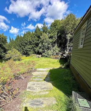 Stroll along the winding pathway to a tranquil elevated deck, offering breathtaking views of the lush surroundings.