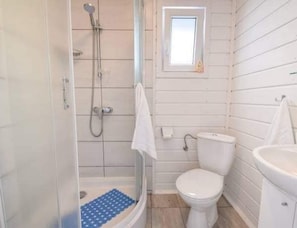 A bathroom with a shower, toilet, and sink. - Single-story Holiday Homes With Terraces (Mielno)