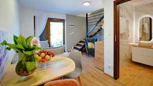 A modern interior with a dining area, a staircase, and a bathroom. - Spacious Holiday Home With a Terrace, Mielenko (Mielno)