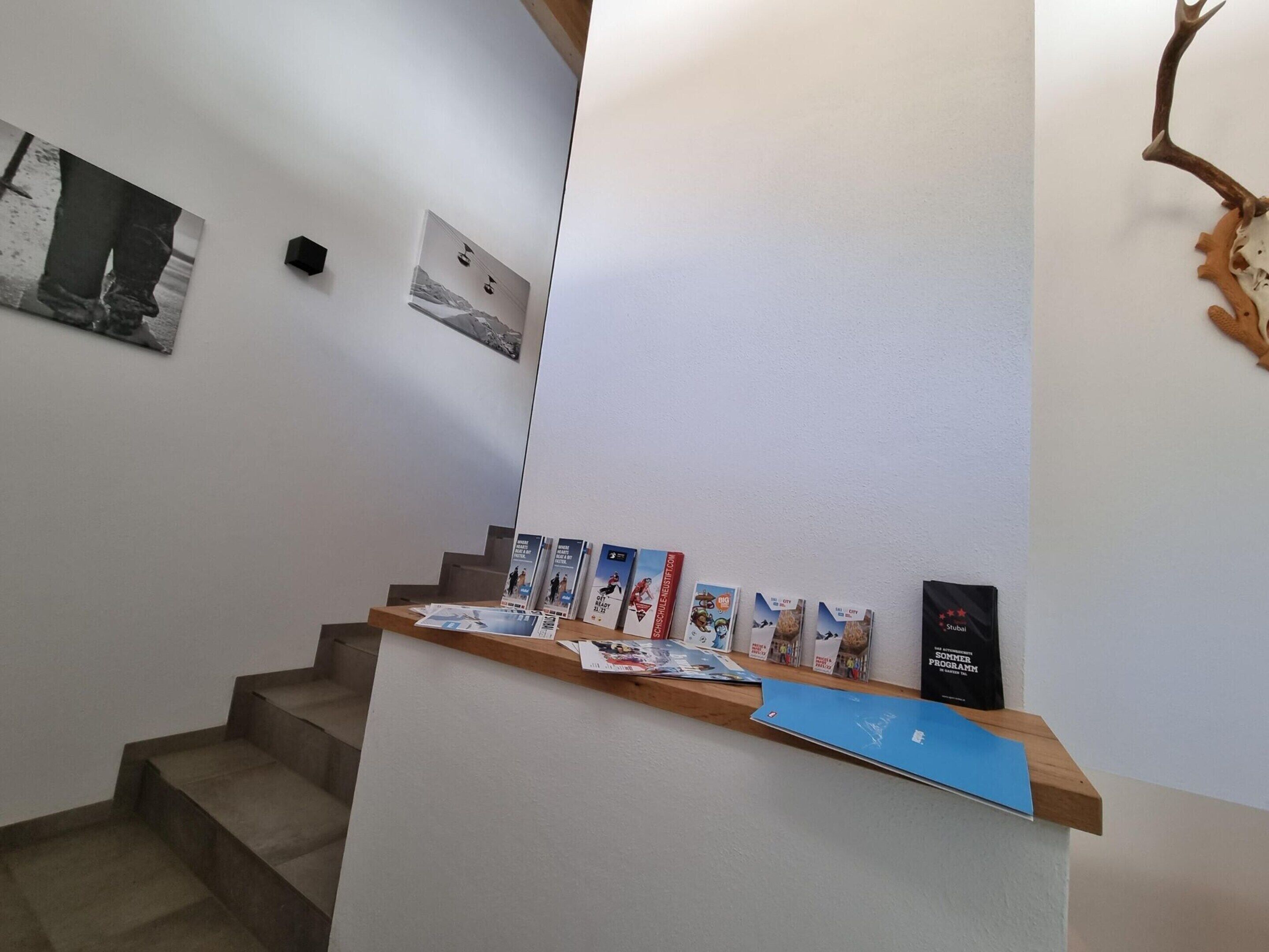 A reception desk with brochures and a black sign.