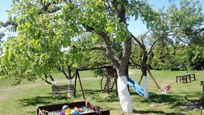A playground with a swing set, slide, and sand play area. - Holiday Houses for 4 People in Rewal-formerly TUI Ferienhaus (Rewal)