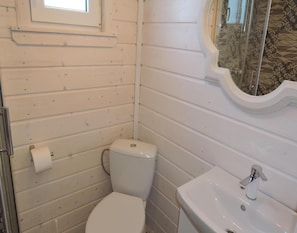 A small bathroom with a toilet, a sink, and a window. - Holiday Home Kolczewo Near Lake and Golf (gmina Wolin)
