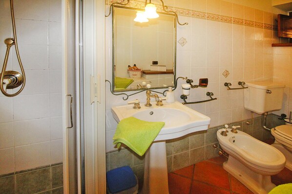 A bathroom with a sink, mirror, toilet, bidet, and shower. - Holiday Home Casa Frantoio II, Camaiore Lombrici (Camaiore)