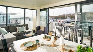 A modern dining area with a view of boats and marina.