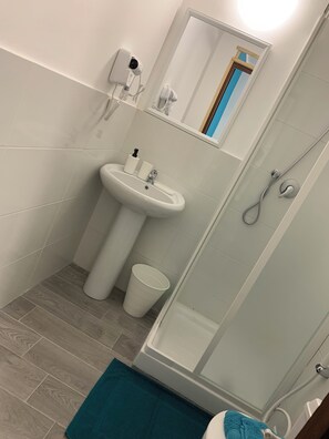 A bathroom with a sink, mirror, and shower. - B&B Sole e Luna (Rome)