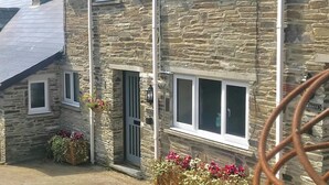 A stone building with multiple windows and a sign that reads "KTREE". - Elmtree Cottage, Cardigan (Cardigan)