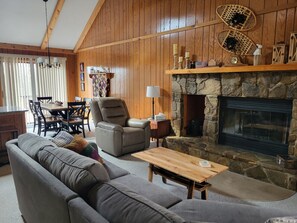 Smart TV, fireplace, books, computer monitors