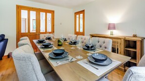 A dining area with a wooden table set for six, surrounded by upholstered chairs. - A magnificent property in a secluded position in Evanton. (Evanton, near Dingwall)