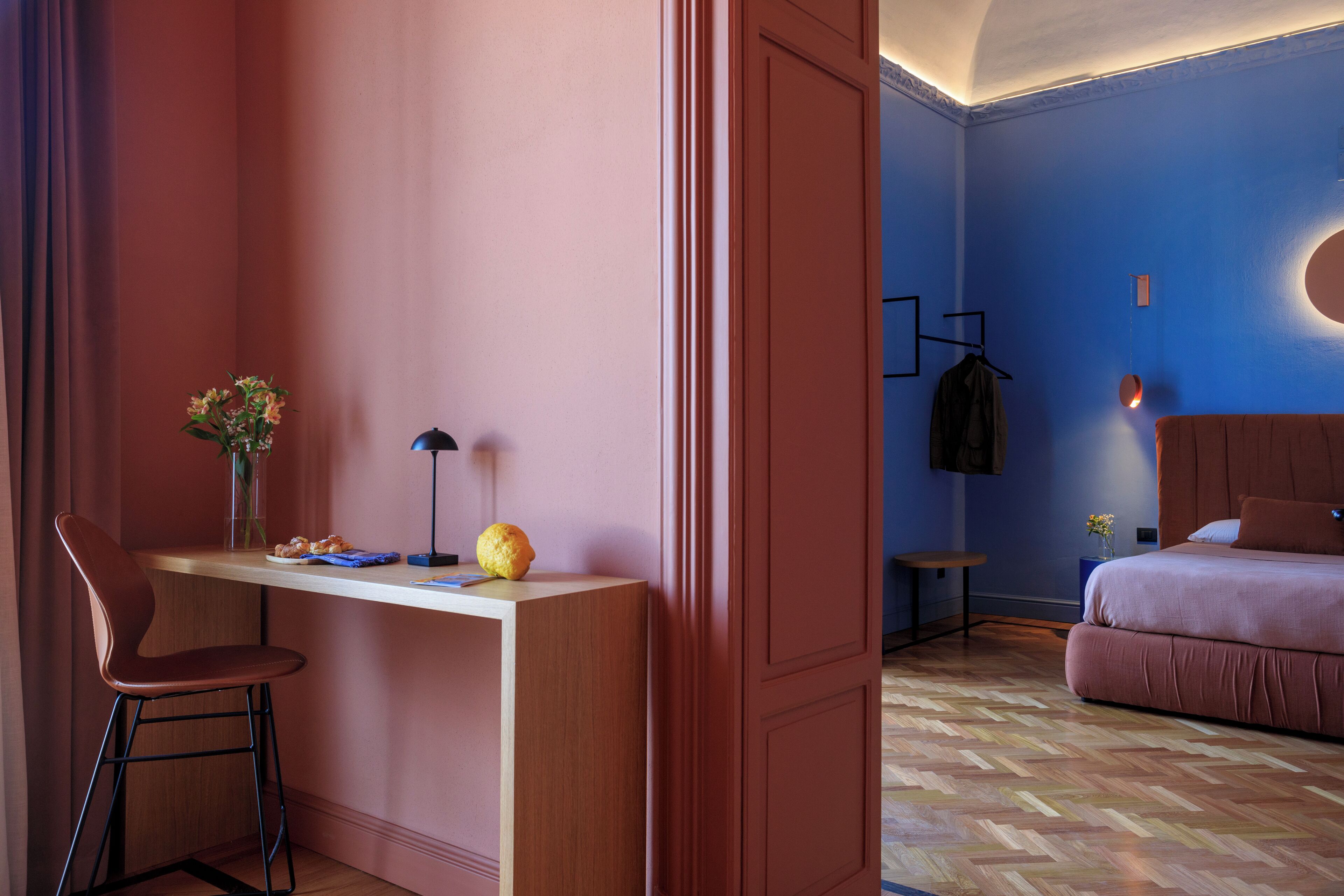A room with a desk, chair, and a bed.