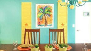 A dining table set with plates, glasses, and potted plants. - SALTWATER SMILES 3/2-HEATED POOL HOME 5 MILES FROM AMI WITH GAMES AND PING PONG. (BRADENTON,)
