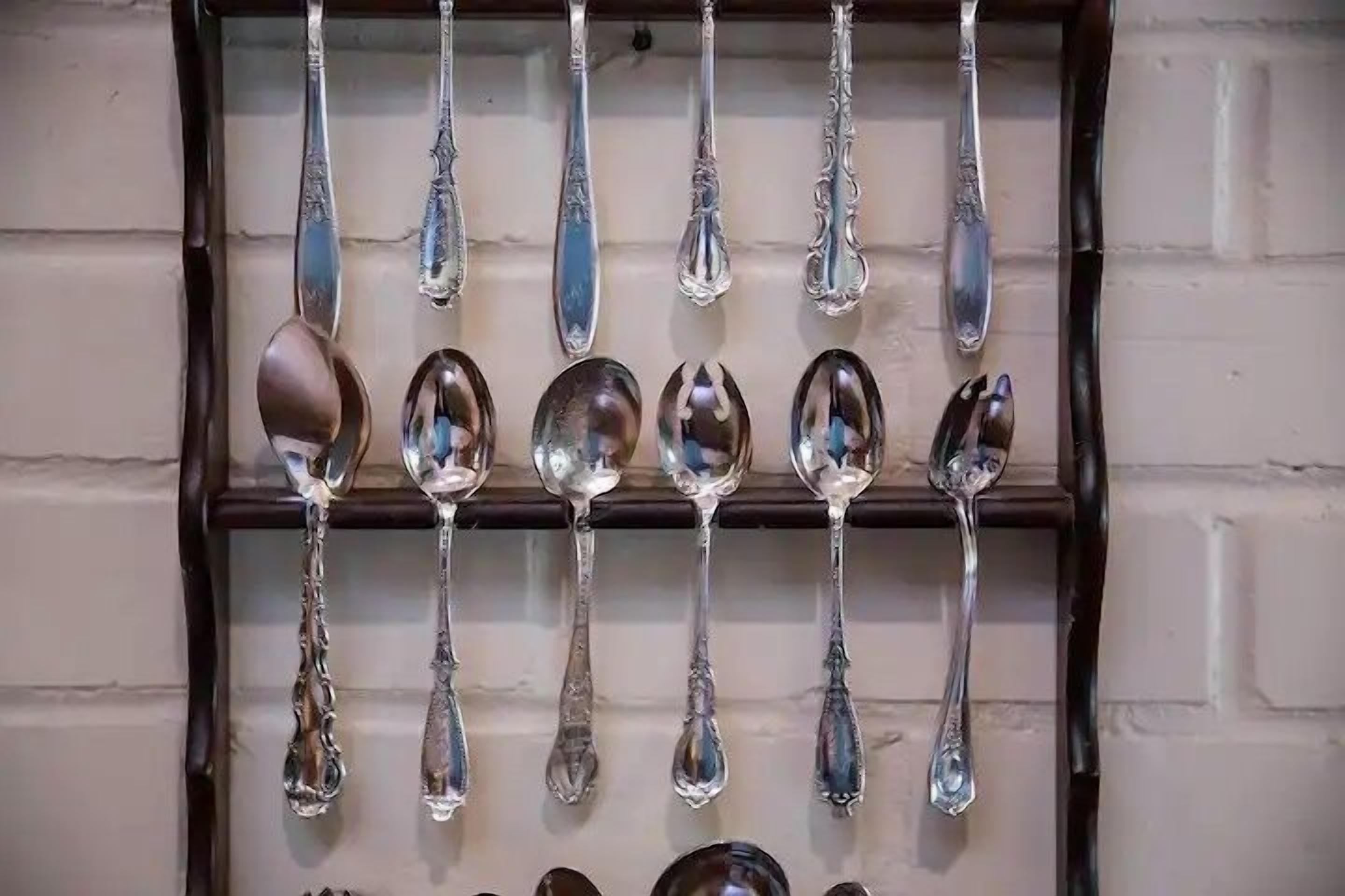 Una exposición de cubiertos colgando en una pared.