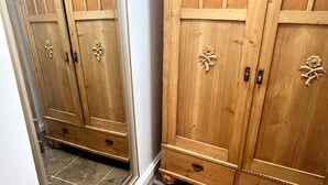 A room with two wooden wardrobes, a mirror, and a tiled floor. - Historic Hilltop Guesthouse - Charming studio/cottage one block from downtown  (Laurel)