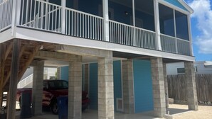 A two-story house with a balcony, a garage, and a fenced yard. - Captain & Mermaid's Diamond #BP25 (Big Pine Key)