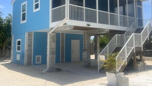 A two-story building with a balcony and a staircase leading to the upper floor. - Captain & Mermaid's Diamond #BP25 (Big Pine Key)