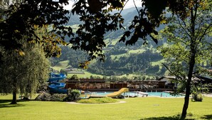 A hotel with a pool, boats, and a view of the surrounding landscape. - Apartment in Fugen Near Spieljochbahn (Fuegen)
