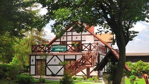 A traditional half-timbered building with a sign indicating it is an apartment. - Apartment in Darlowo Near Seaside Beach (Darlowo)