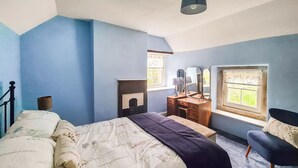 A bedroom with a bed, dresser, chair, and a window with a view. - 2 bedroom accommodation in Aldwark, near Brassington (Aldwark, near Brassington)