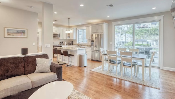 A modern kitchen with white cabinets, stainless steel appliances, and a large island. - Waterfront Escape! NYC Ferry, Beach, Modern New Construction 3 bedroom 3 bath (Highlands)