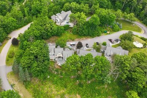 An aerial view of a residential area with multiple houses surrounded by dense greenery. - Mountain Views: Beautiful Nestlenook Farm Home! (Jackson)