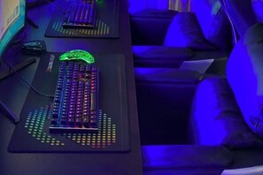 A gaming setup with two illuminated keyboards and a mouse on a desk. - Tonghe Yufeng Hotel (Tonghe)