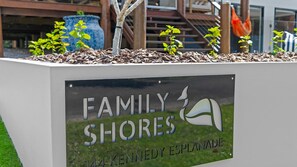 A sign for 'Family Shores' with a logo and address.