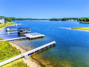 Guests can enjoy serene lakeside views from the wooden docks and walkways, surrounded by lush greenery and natural beauty.