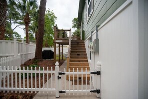 A gated pathway leading to a wooden staircase with a covered area at the top. - Two Unit Duplex-2m Beach Walk (Hilton Head Island)