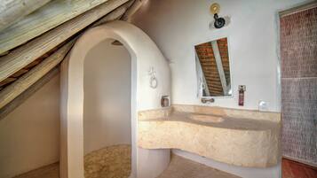 Relax in a spacious bathroom with a bathtub, sink, and mirror.