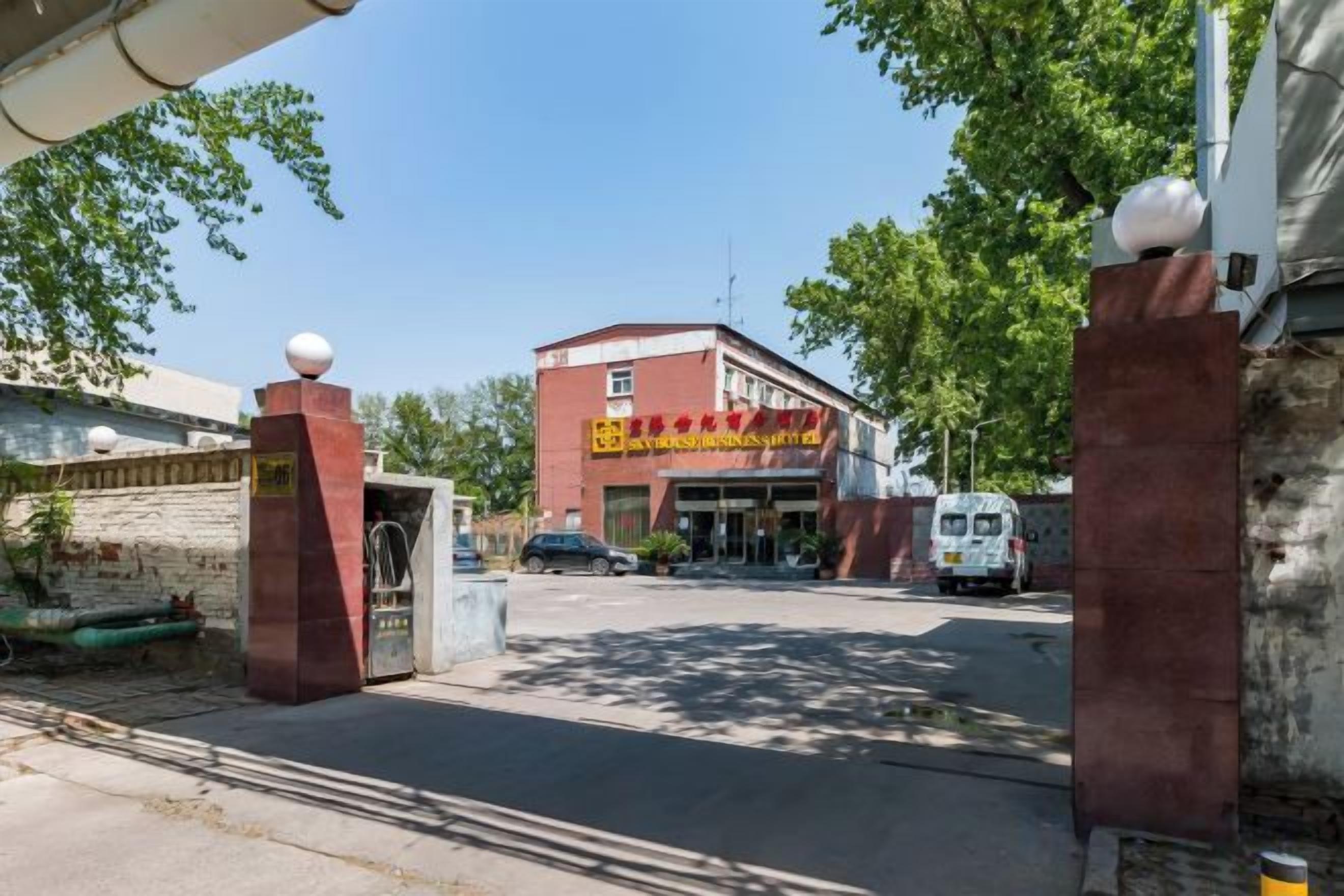 A building with a red facade and a sign with yellow text.