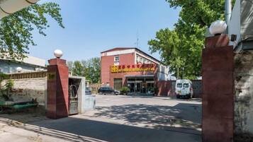 A building with a red facade and a sign with yellow text.