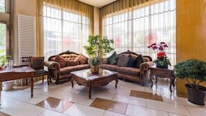A spacious living room with two sofas, a coffee table, and a dining table.