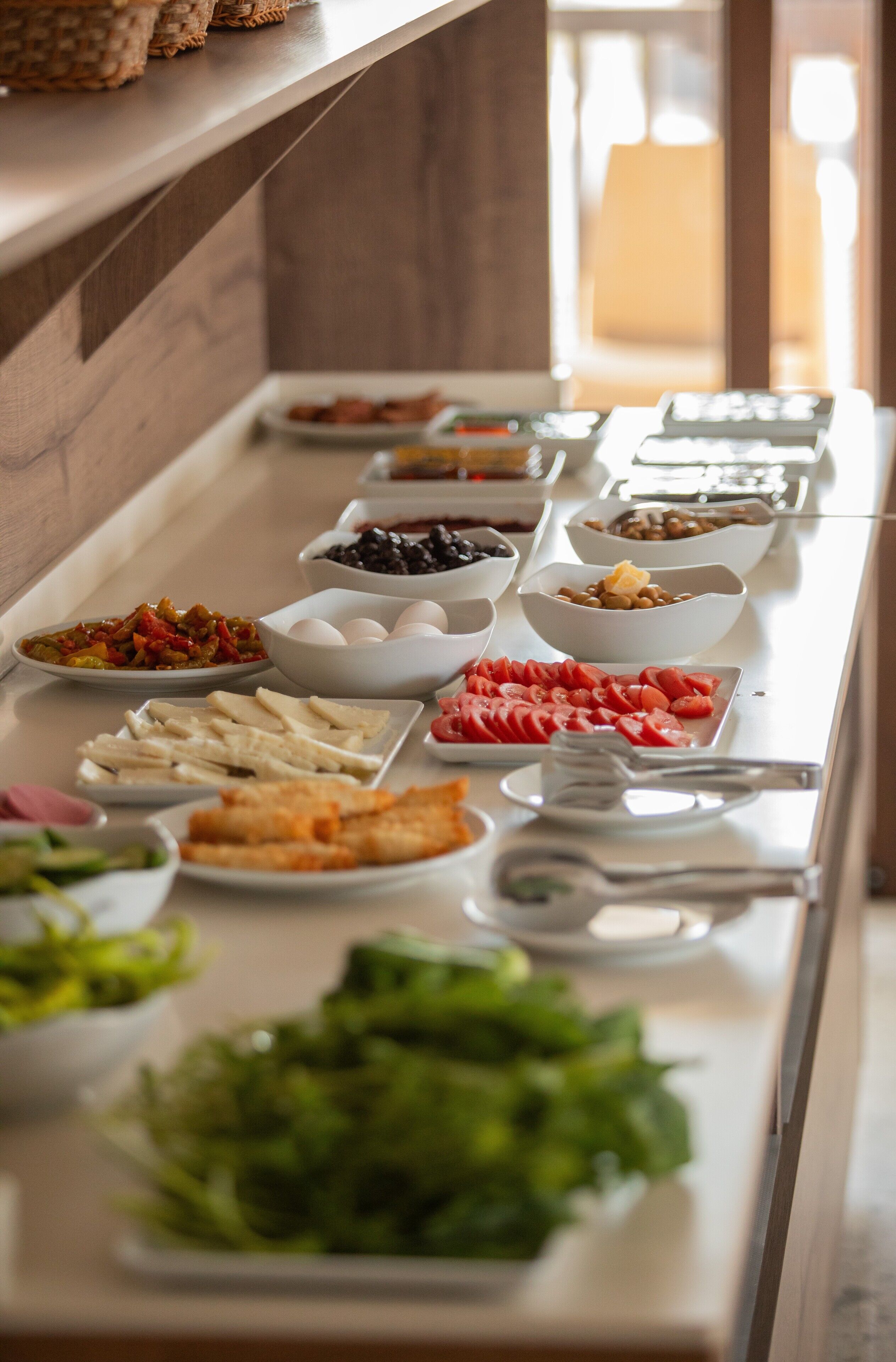 A buffet with various dishes including fruits, vegetables, and proteins.
