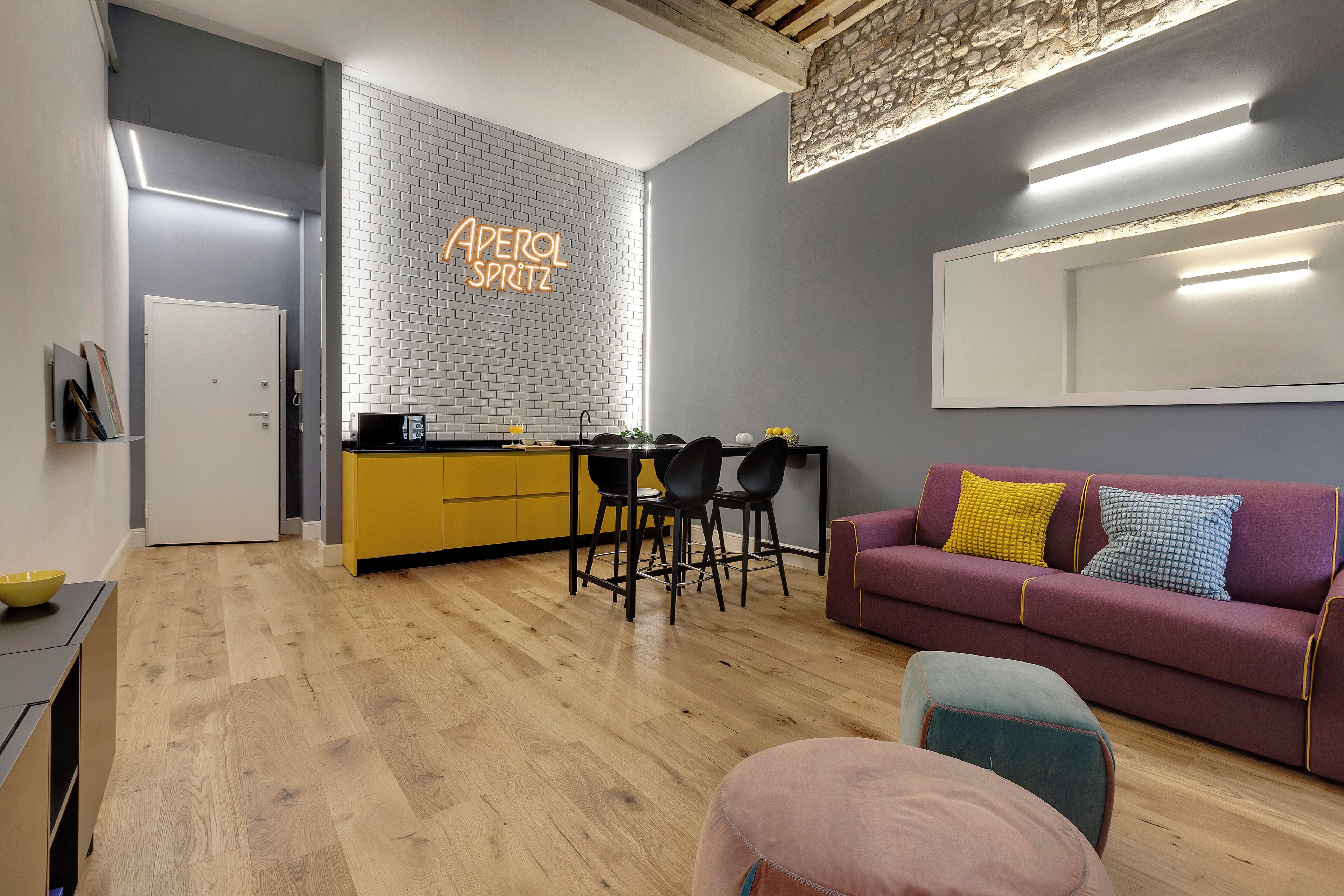 A modern living space with a kitchen, dining area, and seating area.